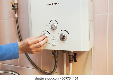 Men Hand Regulate The Power Of Hot Water In Gas Water Heater