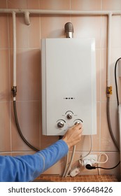 Men Hand Regulate The Temperature Of Hot Water In Gas Water Heater