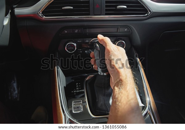Men handle hold to gear stick lever, Start driving\
vehicles.On a hot day.