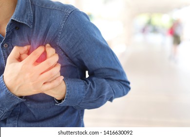 Men have chest pain caused by heart disease, heart attack, heart leakage, coronary heart disease. - Shutterstock ID 1416630092