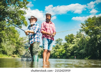 Men hobby and recreation. Fishermen successful catch fish. Fisher retirement. Retired businessman in suit with fishing rod. Male friendship. Granddad and drandson fishing.