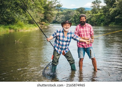 Men hobby and recreation. Fishermen successful catch fish. Fisher retirement. Retired businessman in suit with fishing rod. Male friendship. Granddad and drandson fishing. Happy excited man friends.