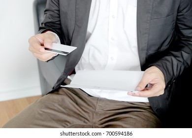 Men Hold Credit Cards And Pay Bills.Debt Settlement Concept