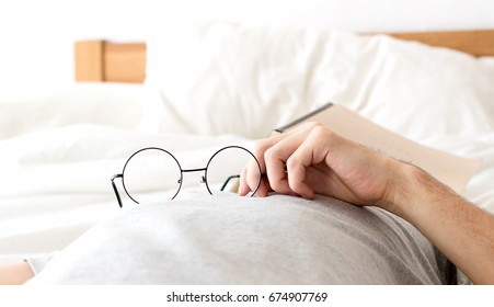 Men hold glasses sleep no bed  with after reading