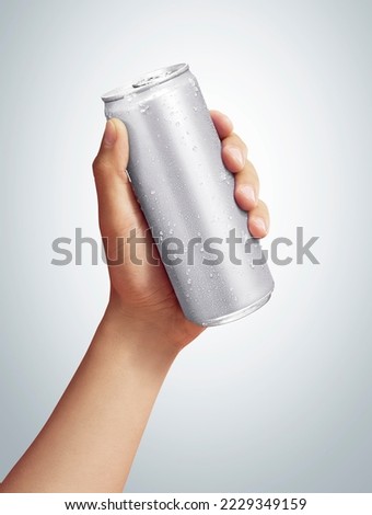 men holding aluminum can with condensation droplet. isolated on grey background.