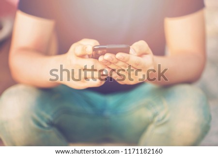 Men holding a phone.Men playing games on the phone.
