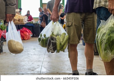 Men Holding Plastic Shopping Bag With Vegetables In A Typical Turkish Greengrocery Bazaar In Eskisehir, Turkey.