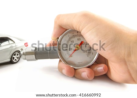 Men holding pressure gauge and checking air pressure of small car model.