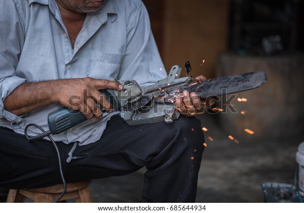 Men holding spare parts in\
hand