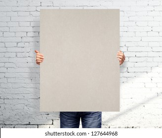 Men Holding White Blank Poster