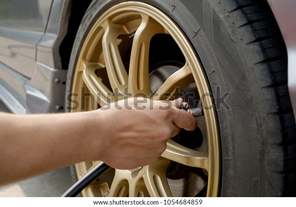 Men are inflating tires\
and car care.