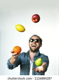 Men Juggling Fruit