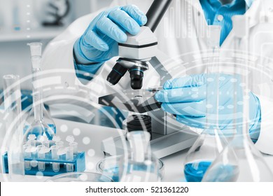 men in a laboratory microscope with microscope slide in hand