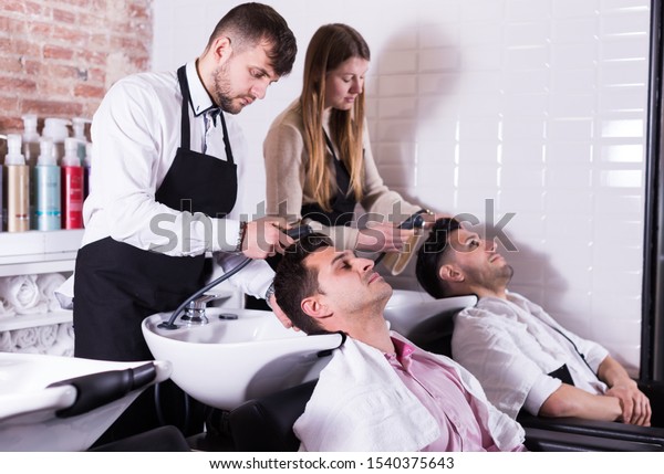 Men Leaning Heads On Sink Relaxing Stock Photo Edit Now 1540375643