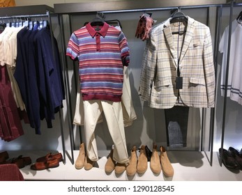 Men leather jacket clothes with row of shirts in clothing store
