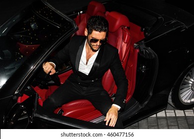 Men In Luxury Car. Night Life.