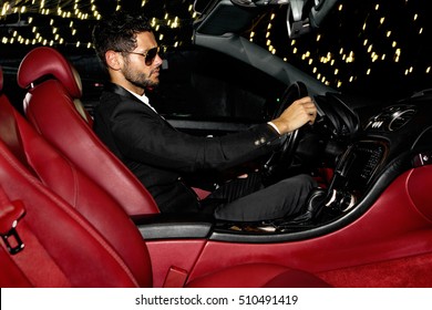 Men In Luxury Car. Night Life.