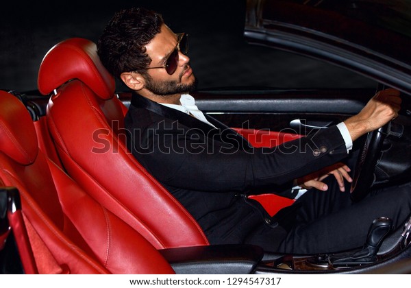Men in luxury car. Night\
life.\
