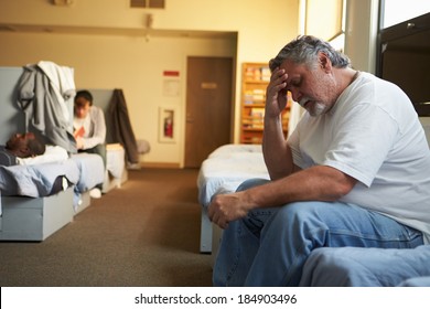 Men Lying On Beds In Homeless Shelter