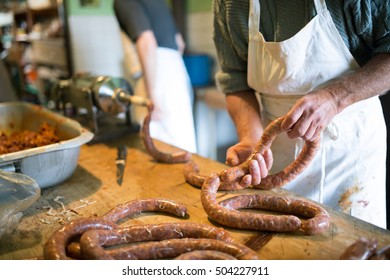 Men making sausages the traditional way using sausage filler. - Powered by Shutterstock