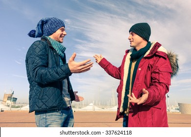 Men Models Wearing Winter Clothes Using Gesturing In Friendly Discussion - Best Male Friends Are Hugging - Trendy Students Having Fun Outdoor In Sunny Day - Concept Of Friendship Happiness And Youth 