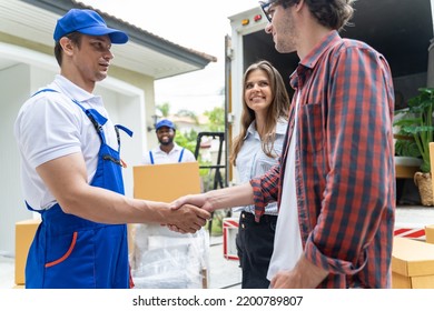 Men Mover Worker In Blue Uniform And Homeowner Making Handshake To Work Success Moving To New House.Homeowner Checking Delivery List Cardboard.african American Worker Unloading Boxes From Van Outdoors