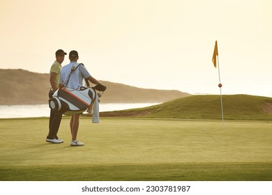Men on golf course overlooking ocean - Powered by Shutterstock