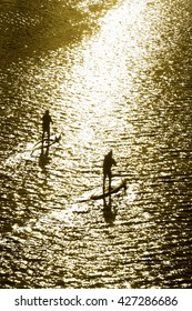 Men On Stand Up Paddle Board In  The Sea ; Sepia Tone