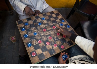 Men Play Checkers In A Pub In Johannesburg, South Africa