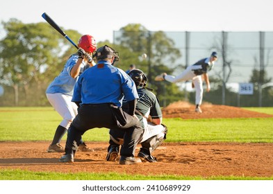 Men playing baseball game. Batter getting ready to hit a pitch during ballgame on a baseball diamond, field. - Powered by Shutterstock
