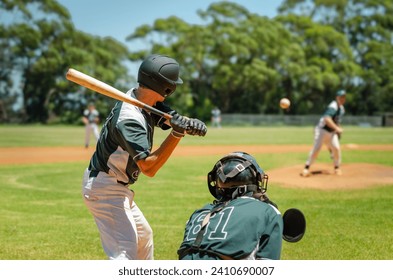 Men playing baseball game. Batter getting ready to hit a pitch during ballgame on a baseball diamond, field. - Powered by Shutterstock