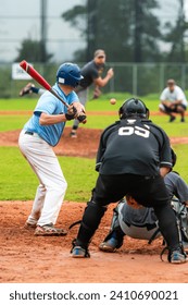 Men playing baseball game. Batter getting ready to hit a pitch during ballgame on a baseball diamond, field.