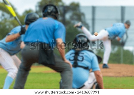 Men playing baseball game. Batter getting ready to hit a pitch during ballgame on a baseball diamond, field.