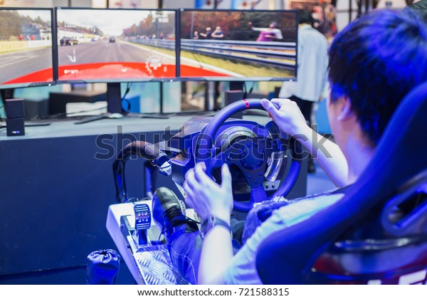 Men\
are playing a racing game. Joy games driving gamer.\
