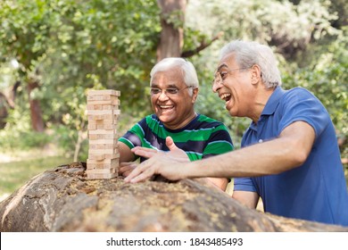 Men playing wooden blocks in park