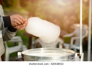 Men is preparing candy floss in the park. Children Day
