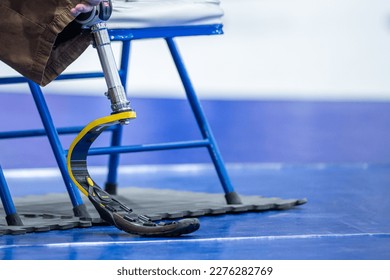 men with prosthetic leg sitting on a chair - Shutterstock ID 2276282769