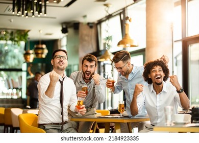 Men At The Pub Watcing Football Game And Drinking Beer.