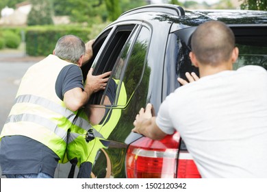 Men Pushing A Car During Break Down