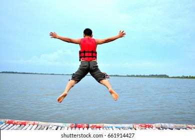 Men put on a life jacket to jump into the lake - Powered by Shutterstock