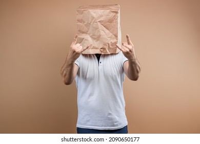 Men put a paper bag on their heads, shows strength, biceps, motivation, support, chorism. Isolate on yellow background, images are easy to crop for use anywhere, copy space