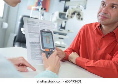 men reading a document with a reader in an office