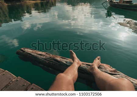 Men relaxing in lake side.
