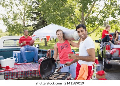 Men relaxing at tailgate barbecue in field - Powered by Shutterstock