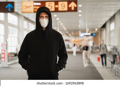Men In Respirator Mask Is Waiting Next Plane At The Airport. Coronavirus COVID-19 And Air Pollution Concept.