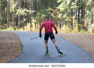 Men Ride Roller Skis In The Autumn Park.