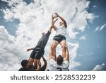 Men, rugby and players with ball or blue sky for scrum, match or game in outdoor tournament or competition. Male person, athlete or sports team with lift for lineout throw, training or practice