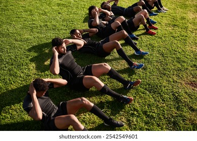 Men, rugby and sit ups with team on grass field for training, practice or outdoor workout for game or match. Active, group or football players in sport, line or row for fitness, crunches or warm up - Powered by Shutterstock