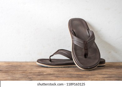 Men Sandals Footware Brown On Wood Grunge Table Desk With Copy Space.