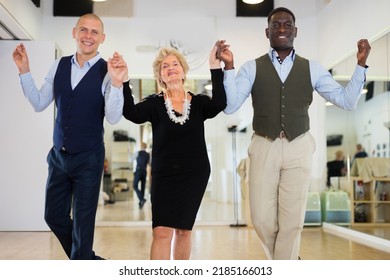 Men And Senior Woman Swing Dancers Standing